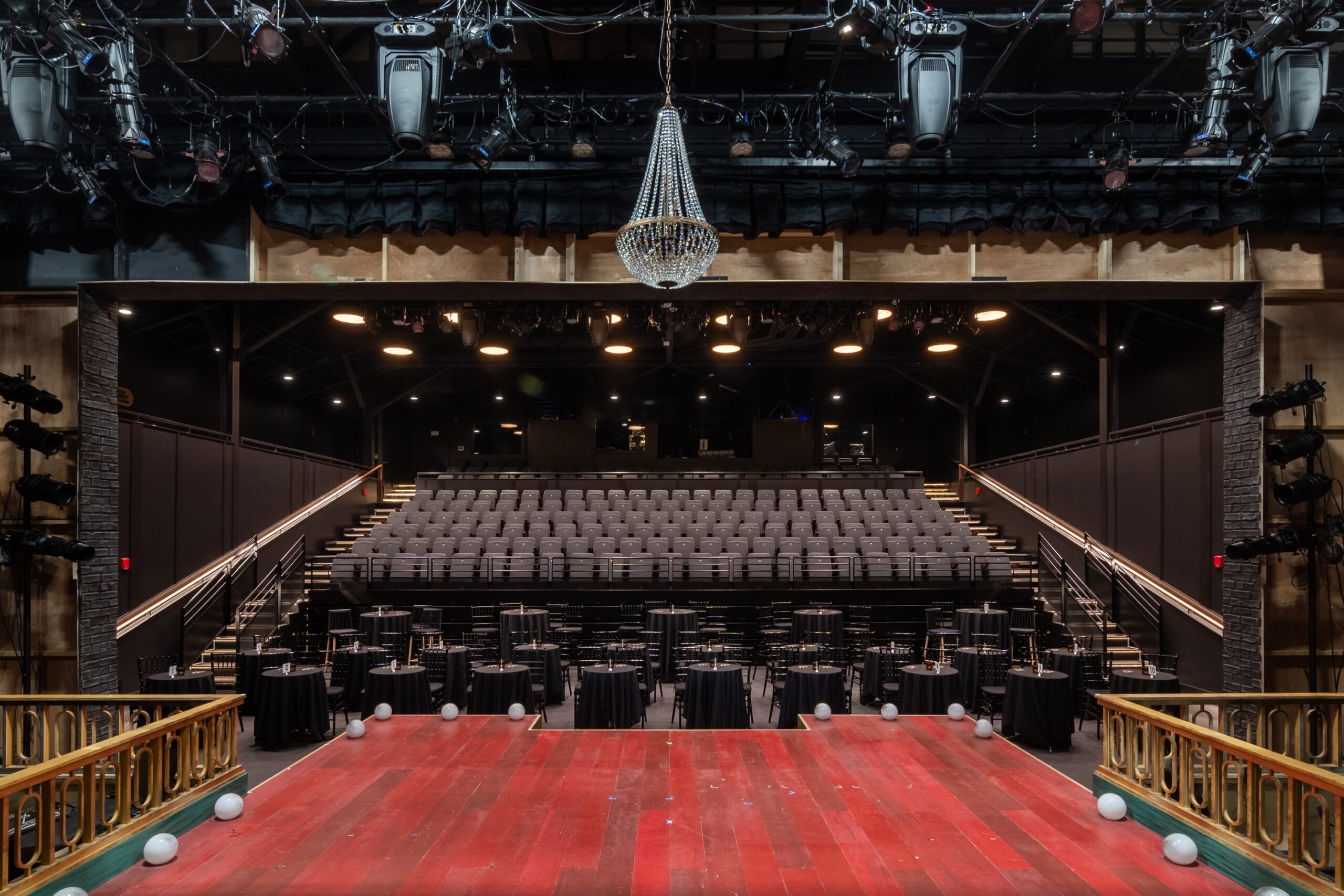 Interior of Turner Theater at The Factory at Franklin, featuring a fixed upper seating area and retractable main-level seats in a modern proscenium-style configuration.
