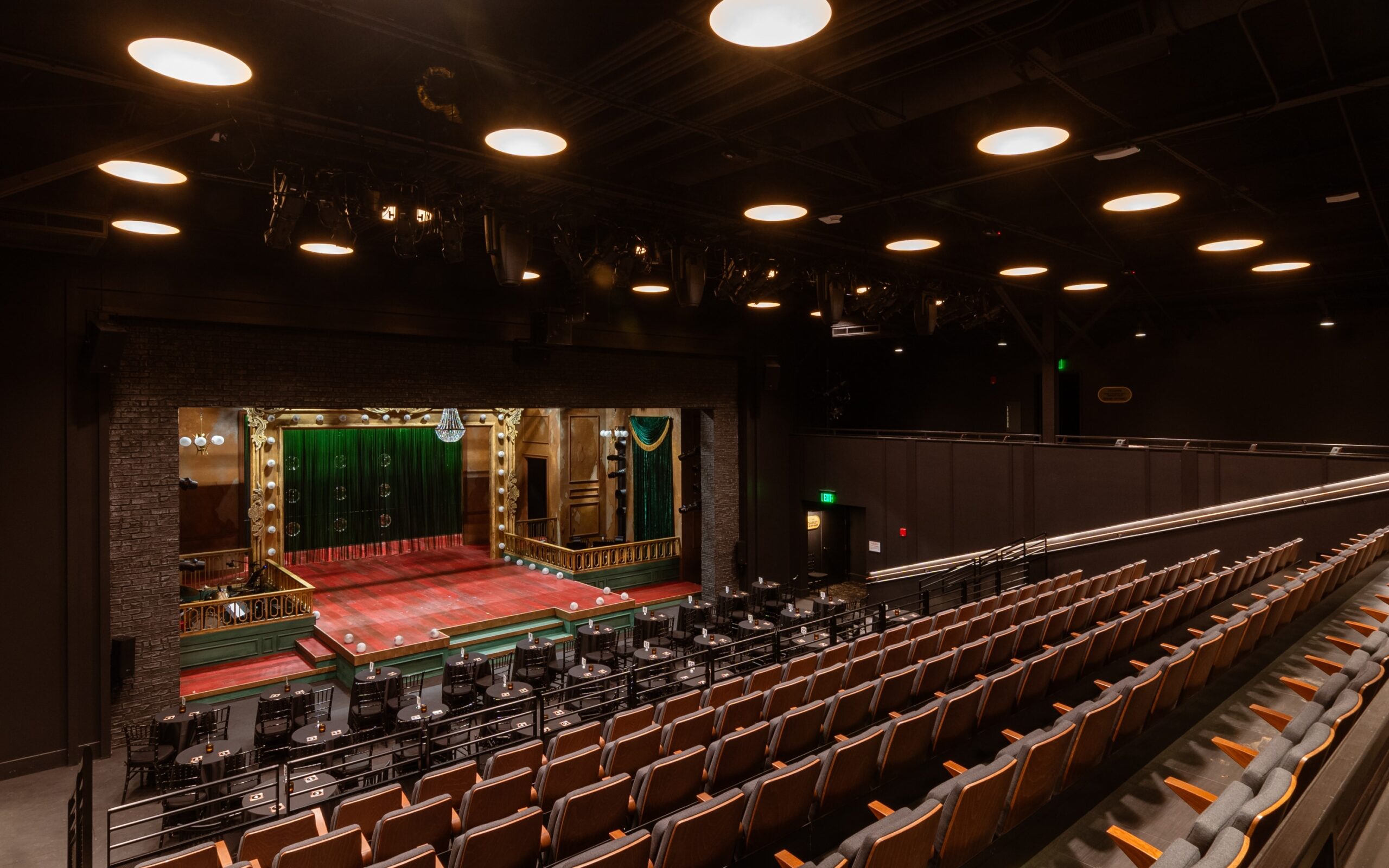 Turner Theater reconfigured for a cabaret performance setup, showcasing flexible seating options and integrated theatrical lighting systems.