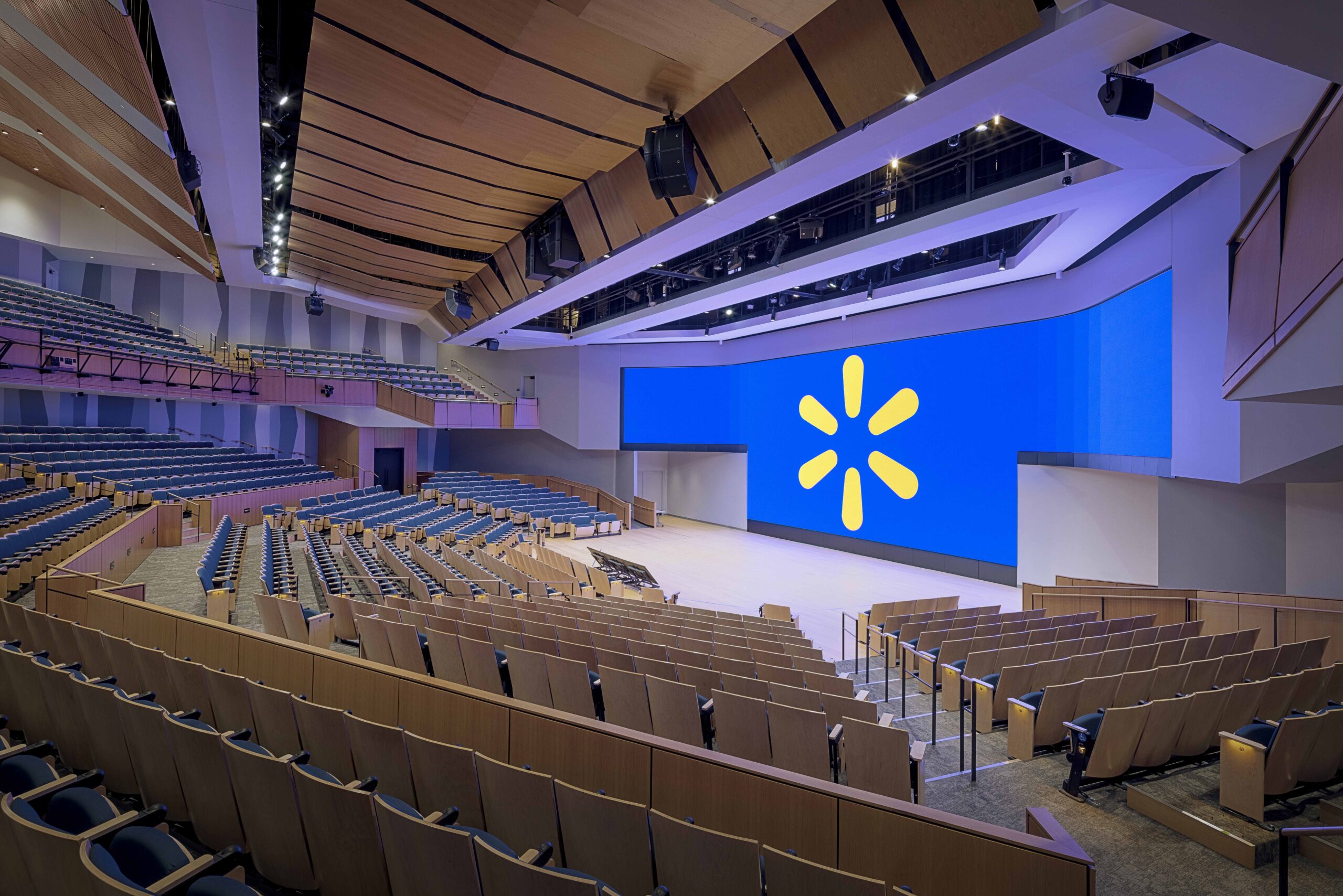 Theatre design by Apeiro Design showcased in Sam Walton Hall’s 1,500-seat auditorium with integrated AV, lighting, and rigging systems.