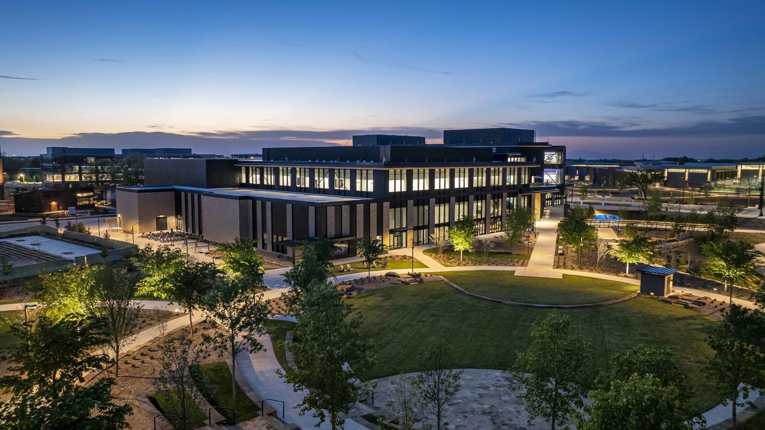 Walmart Sam Walton Hall exterior showcasing modern architecture housing auditorium, training spaces, and media/broadcast studios.