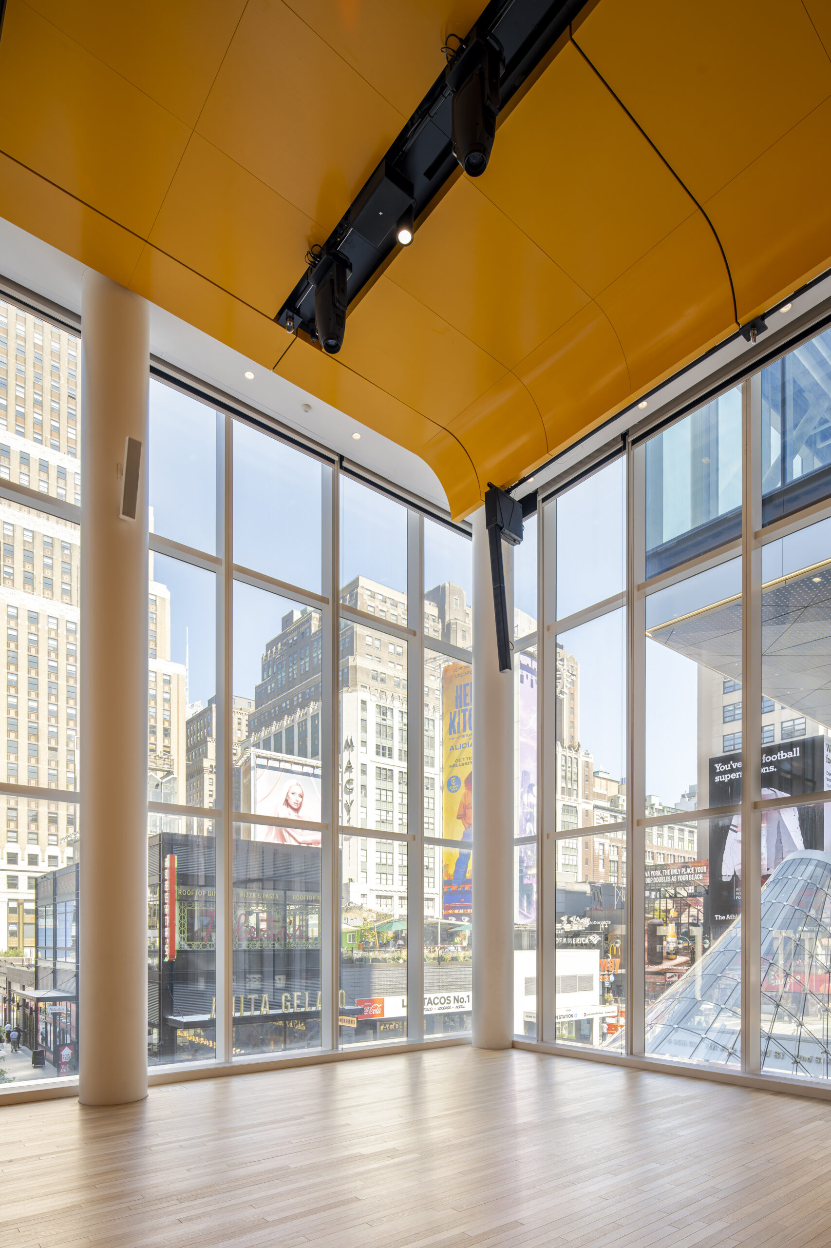 Daylight view of PENN 2 showing the Town Hall suspended above the 33rd Street plaza.