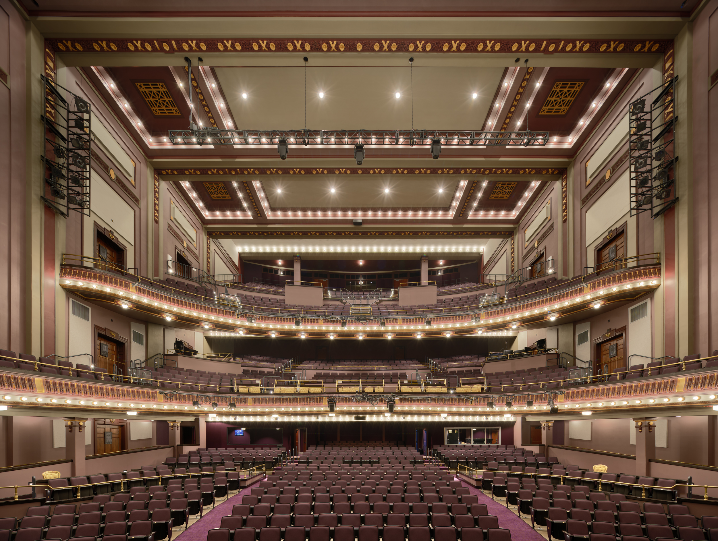 View from the stage toward the auditorium at The Children’s Theatre of Cincinnati, showcasing restored architecture, upgraded house lighting, and immersive audience design.