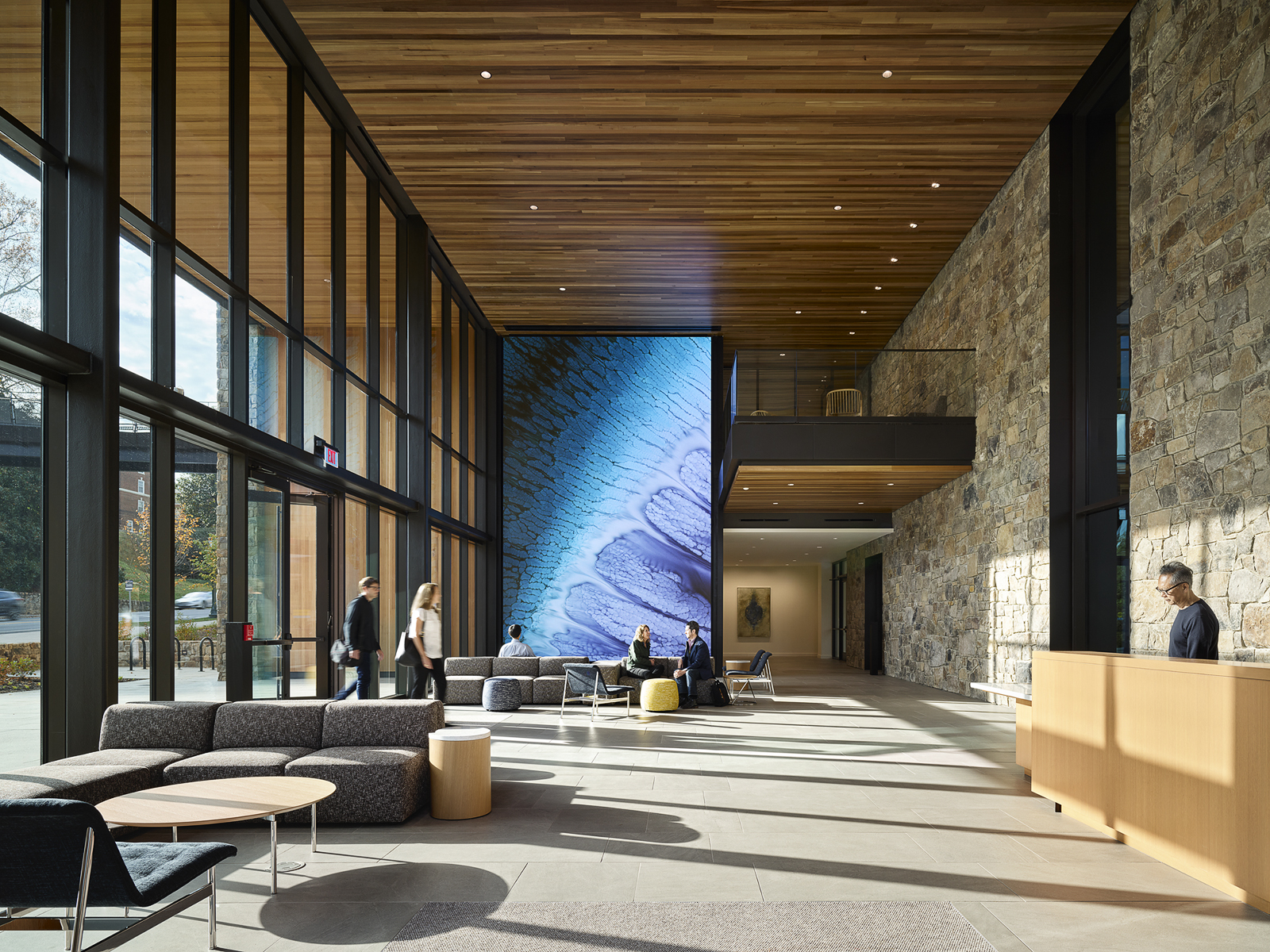 A floor-to-ceiling 16x24-foot Planar DirectLight Ultra Series LED video wall displaying a nature scene in the lobby of the University of Virginia's Contemplative Sciences Center, designed by Apeiro Design. Convergence Hall at the Contemplative Commons with integrated AV and projection systems.
