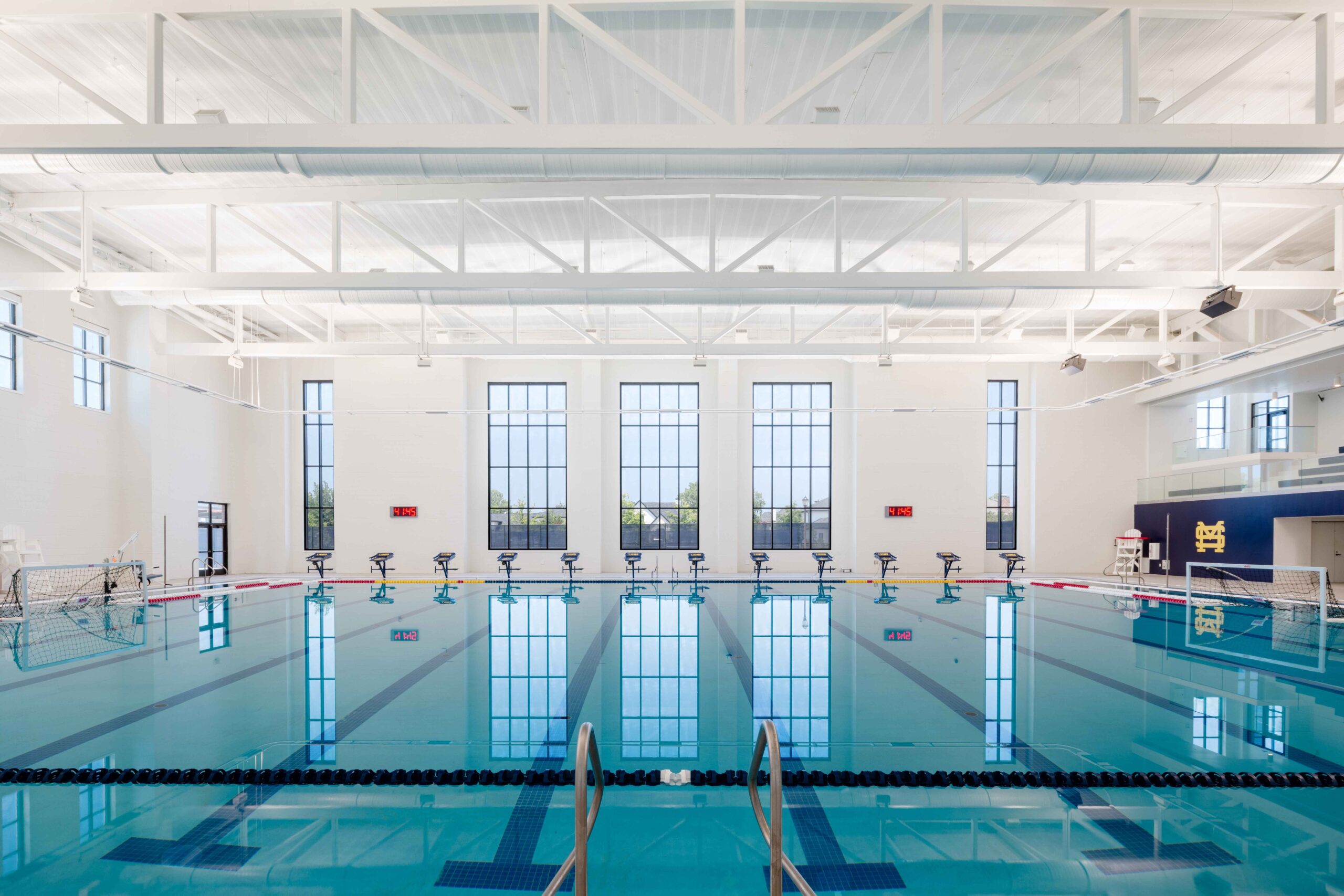 Natatorium at the Zierk Athletic and Aquatic Center illuminated by architectural lighting from Apeiro Design.